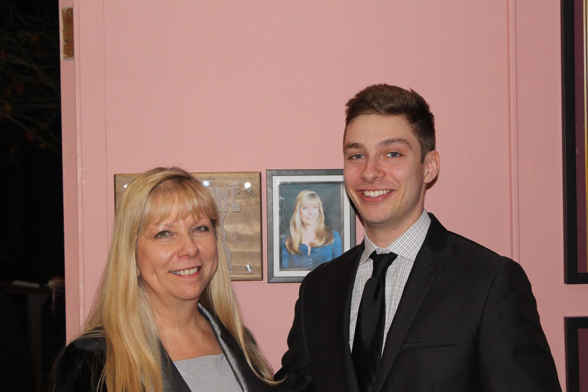 Jacqueline Philips and her son Michael with the sign dedicating the theater